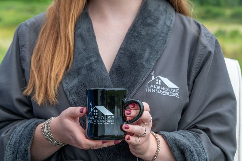 model in a spa robe with a coffee mug