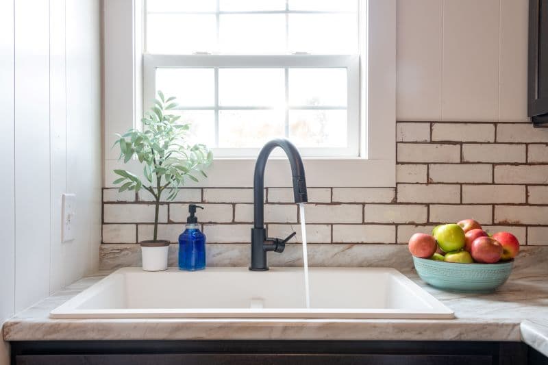 kitchen sink with window and apples in a bowl