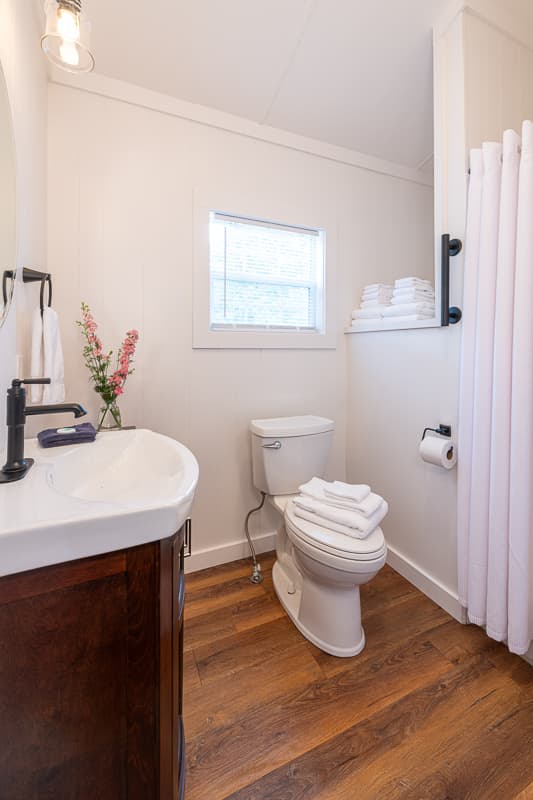 bathroom with toilet, vanity and single shower stall